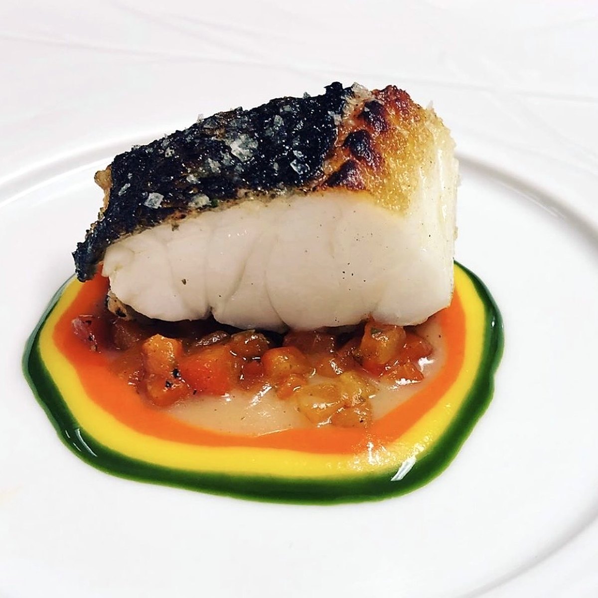 Charred fish on a three-colour sauce